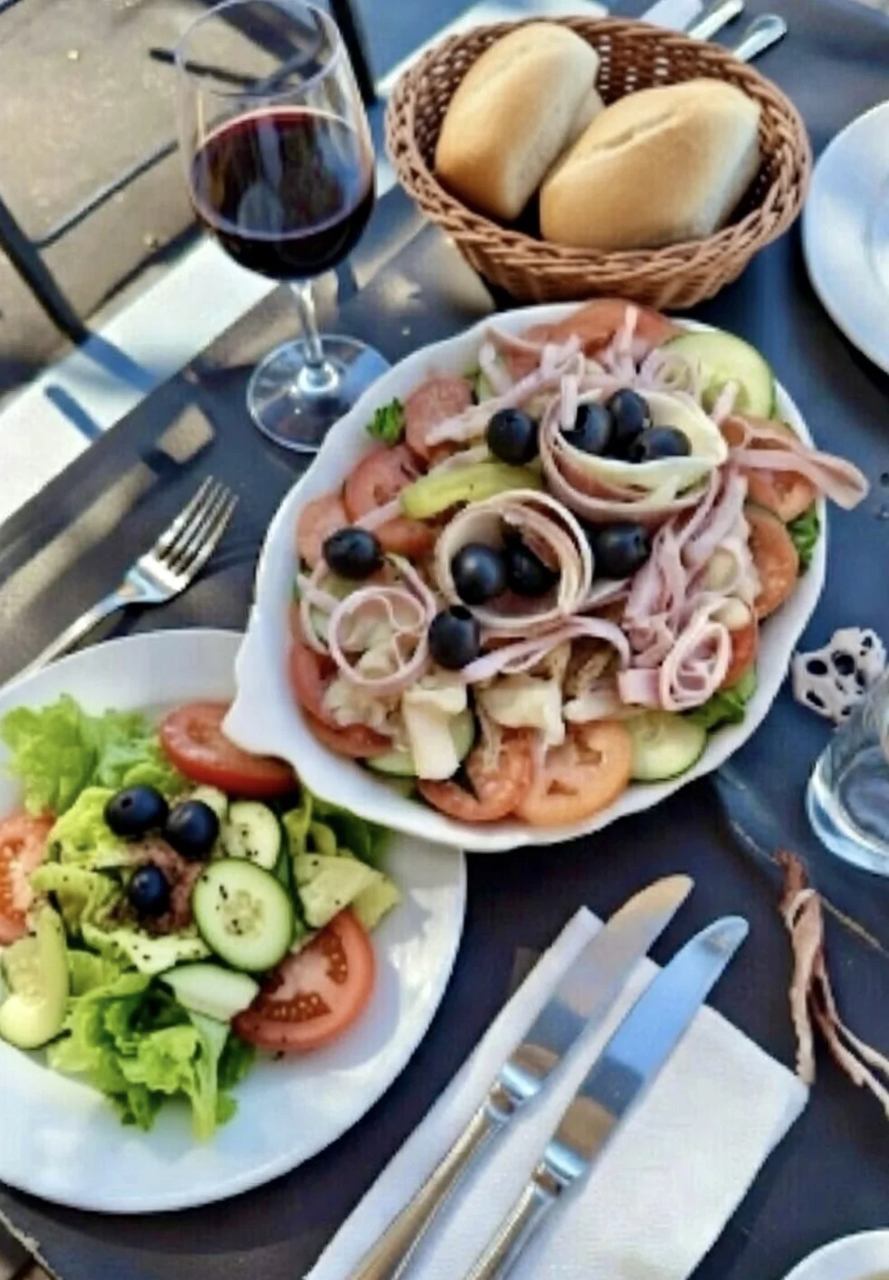 Italian antipasto salad with ham, cheese, olives, and fresh vegetables